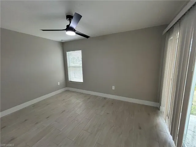 Spare room with light wood-style flooring and ceiling fan