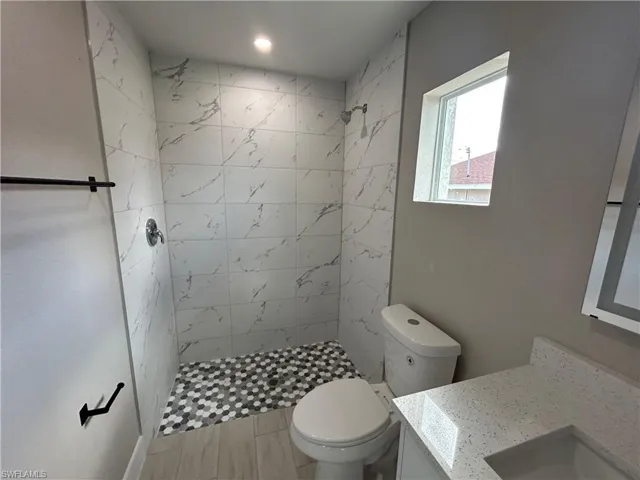 Bathroom featuring vanity and a shower stall
