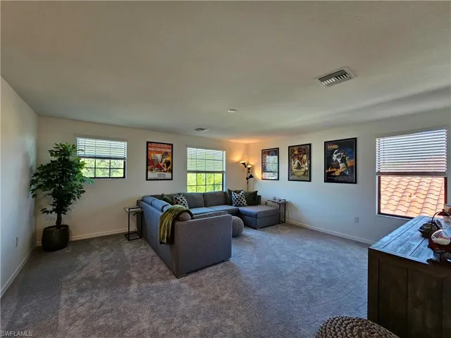Living area with carpet flooring and baseboards