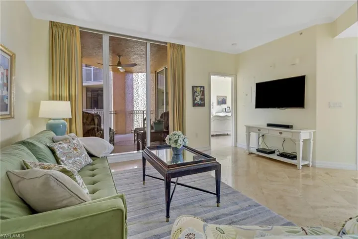 Living room with ceiling fan and ornamental molding
