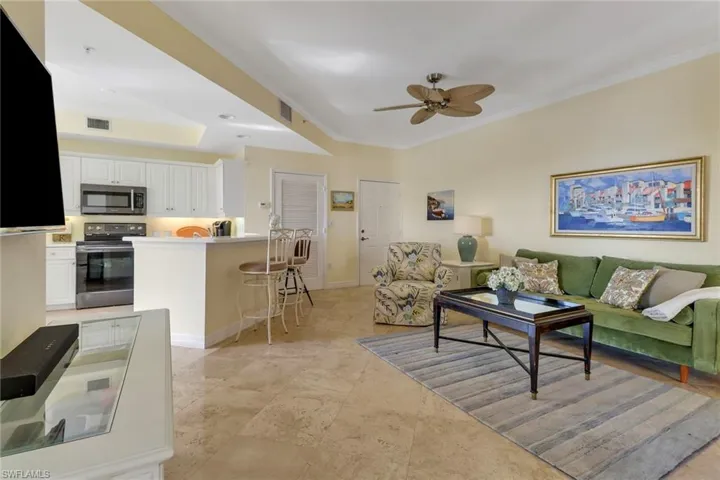 Living room featuring ornamental molding and ceiling fan