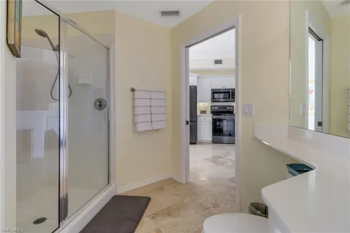 Bathroom featuring toilet and an enclosed shower
