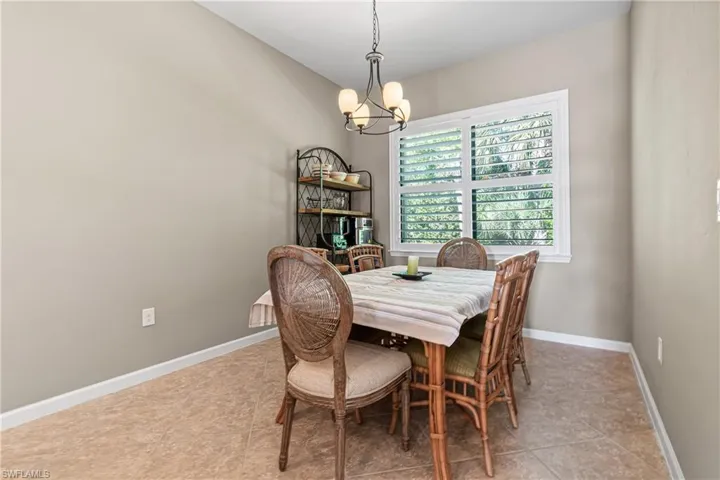 Dining area featuring a chandelier and light tile patterned floors