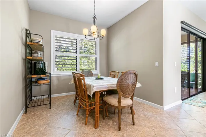 Dining room featuring a chandelier and light tile patterned floors
