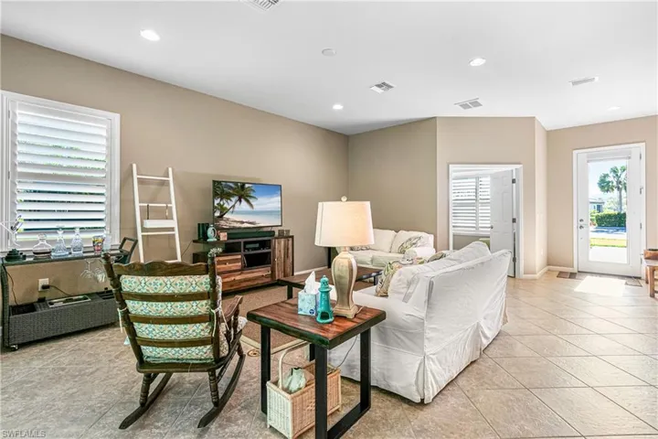 Living room with recessed lighting and light tile patterned flooring