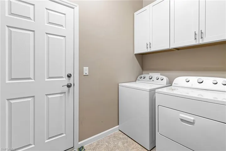 Laundry room with independent washer and dryer and cabinet space