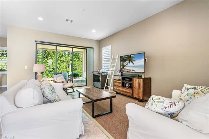 Living area with healthy amount of natural light and recessed lighting