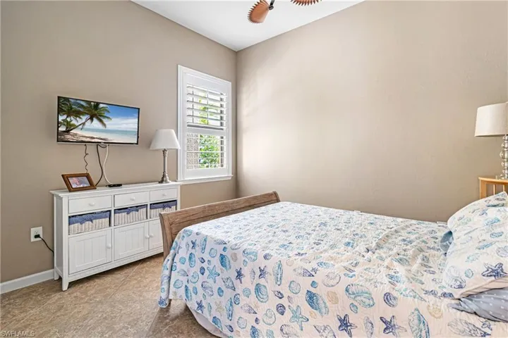 Bedroom with baseboards and tile patterned floors