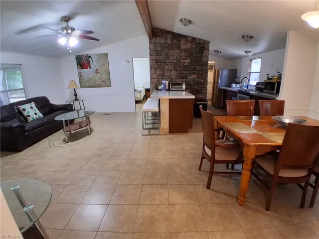 Dining space featuring beam ceiling and a ceiling fan