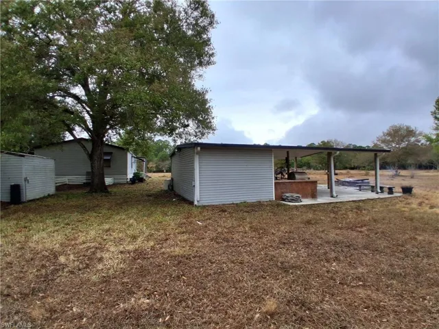 View of green lawn featuring a patio area
