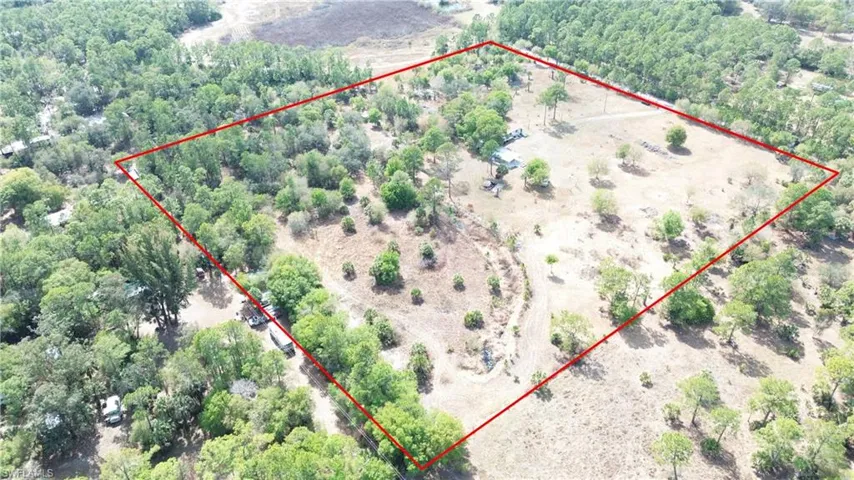 Overview of rural landscape featuring a heavily wooded area and property boundaries highlighted