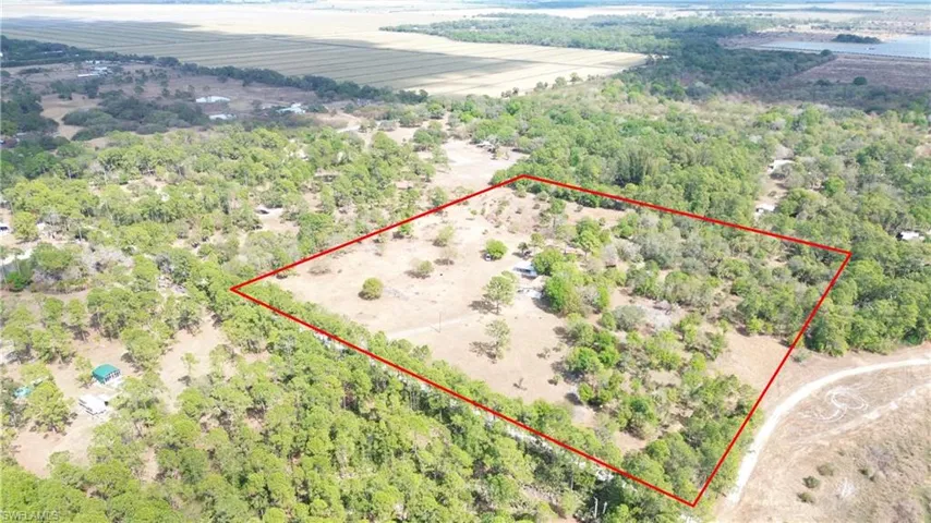 Overview of rural landscape with property boundaries highlighted and a heavily wooded area