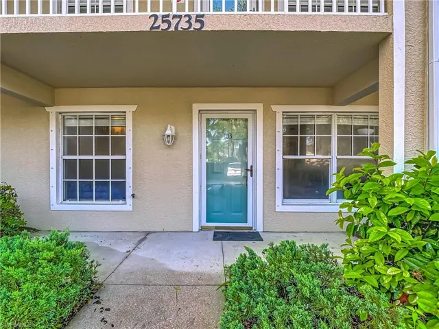 Property entrance featuring stucco siding