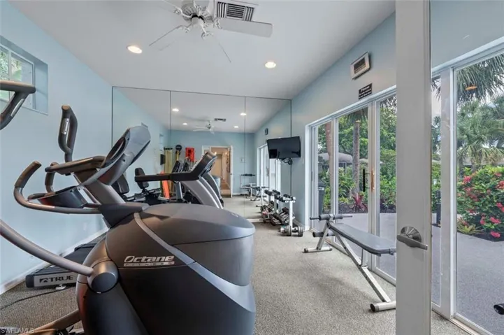 Gym with ceiling fan and recessed lighting