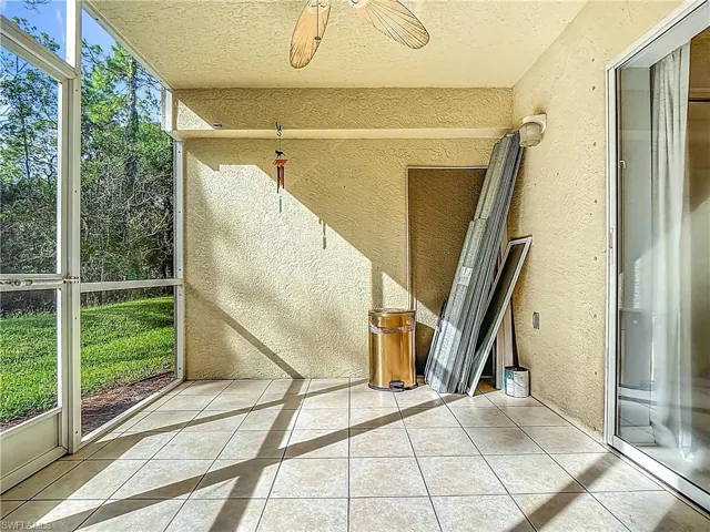 Unfurnished sunroom featuring ceiling fan