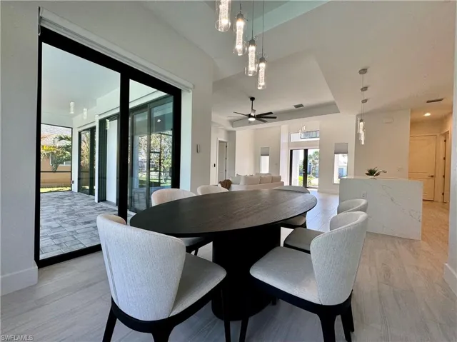 Dining room featuring ceiling fan and light hardwood / wood-style flooring