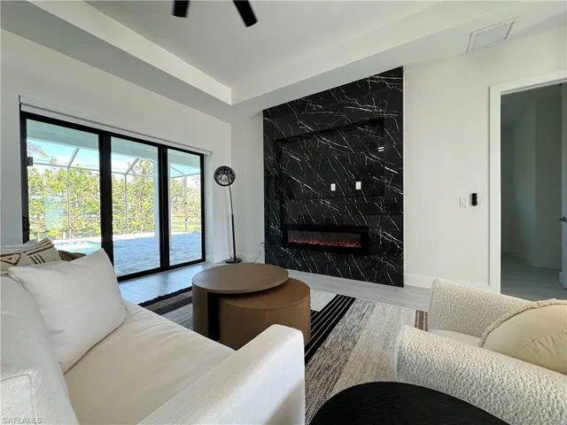 Living room featuring a premium fireplace and hardwood / wood-style flooring