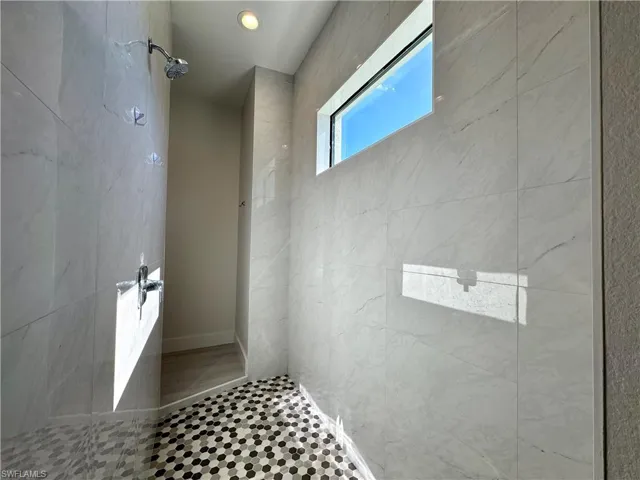 Bathroom featuring tiled shower