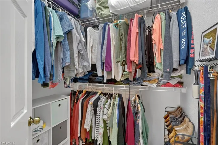 Walk-in closet featuring wire shelving and hanging rods
