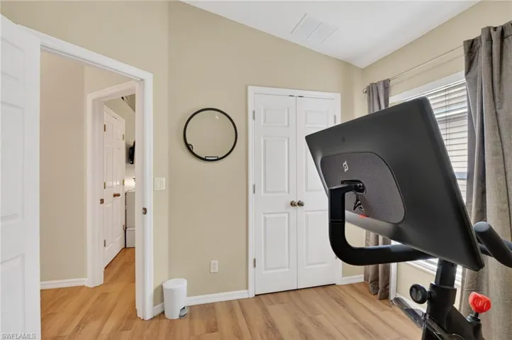 Room featuring wood-finish flooring and a vaulted ceiling