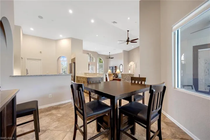 Dining room with light tile flooring and ceiling fan