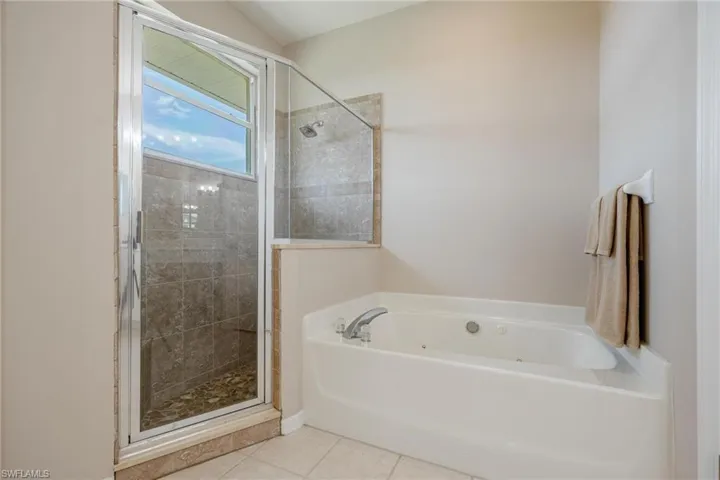 Bathroom featuring tile floors and independent shower and bath
