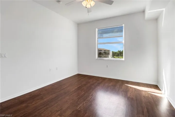 Empty room with wood-type flooring and ceiling fan