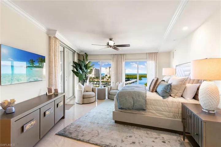 Bedroom with a water view, ceiling fan, and ornamental molding