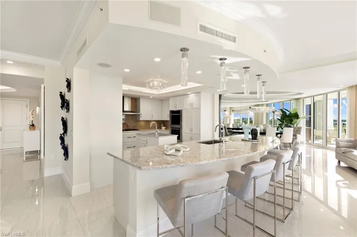 Panorama View of Kitchen, Casual Bar, Living Room and Dining Room from Breakfast Area