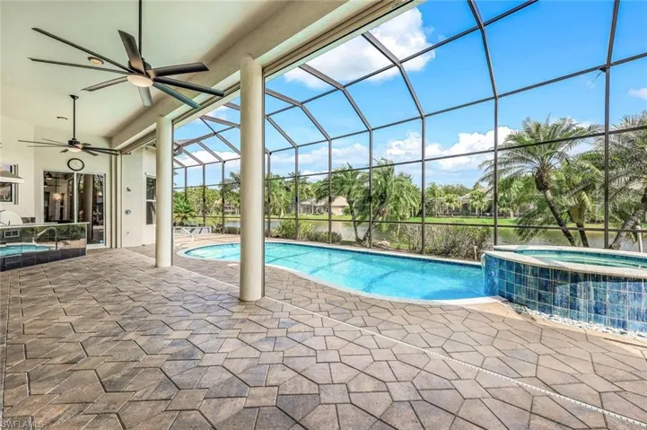 View of swimming pool and in ground spa, outdoor ceiling fans, and extended 80 foot patio.