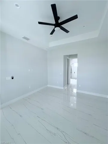 Empty room featuring ceiling fan