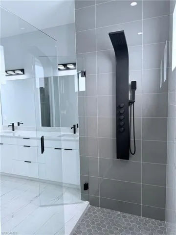 Bathroom with walk in shower and vanity