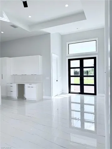 Foyer featuring french doors and a tray ceiling