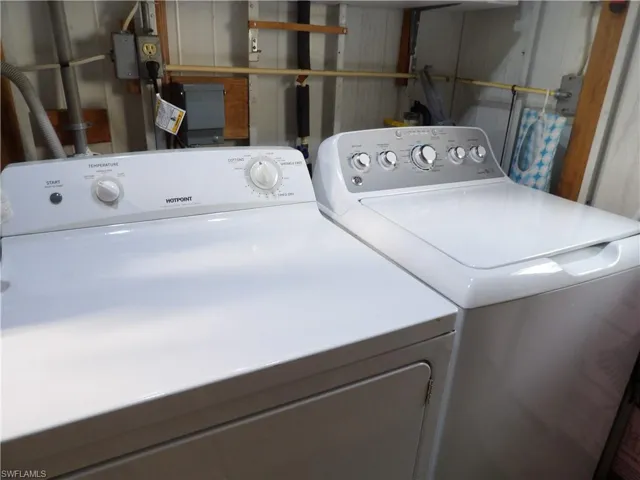 Clothes washing area featuring separate washer and dryer