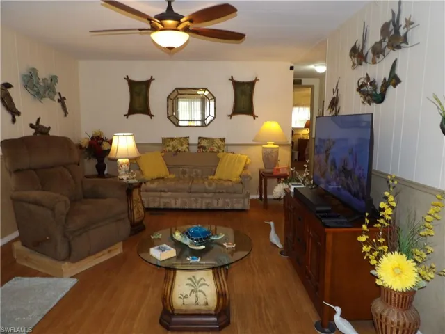 Living room featuring ceiling fan and wood-type flooring