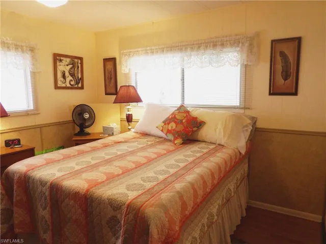 Bedroom with dark hardwood / wood-style floors