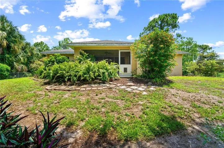 View of front of property with stucco siding, a ceiling fan, and a sunroom