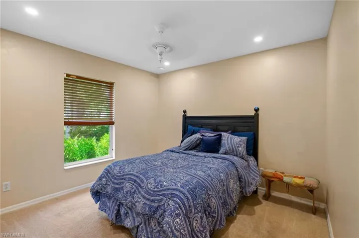 Carpeted bedroom featuring recessed lighting and a ceiling fan
