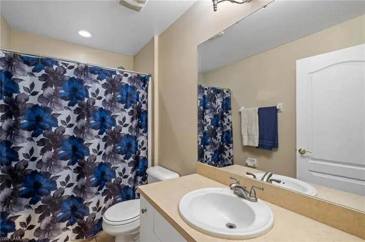 Full bath featuring vanity and curtained shower
