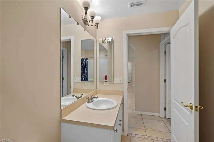 Full bathroom featuring vanity and tile patterned flooring