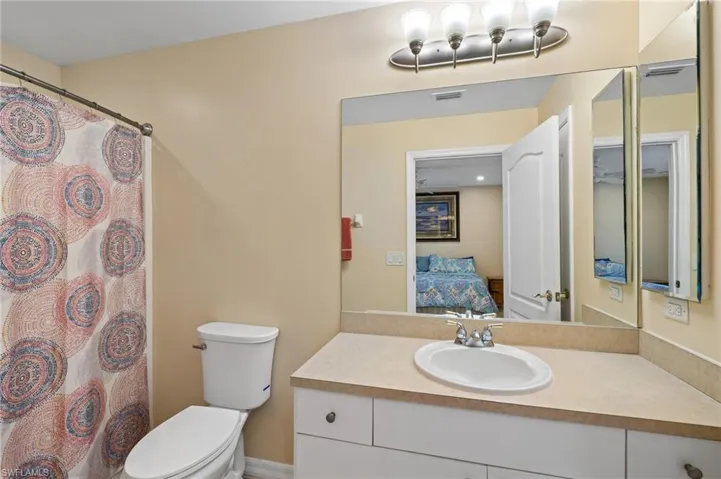 Full bathroom featuring ensuite bath, vanity, and a shower with shower curtain