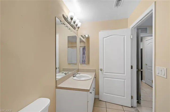 Bathroom with tile patterned floors and vanity