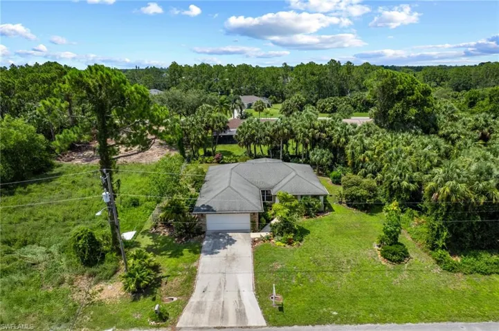 View from above of property featuring a heavily wooded area