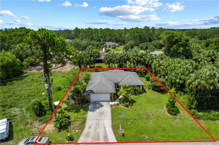 View of subject property with property boundaries highlighted and a heavily wooded area
