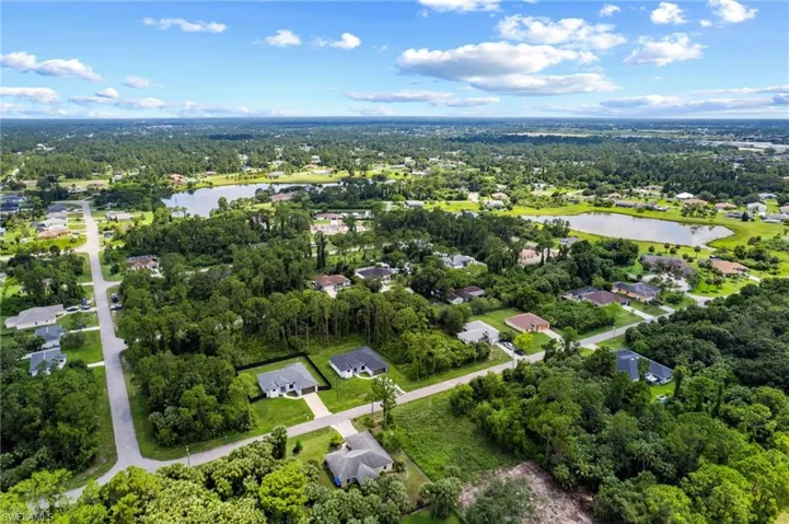 Aerial view of property's location featuring a large body of water and nearby suburban area