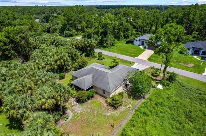 View of subject property featuring a forest