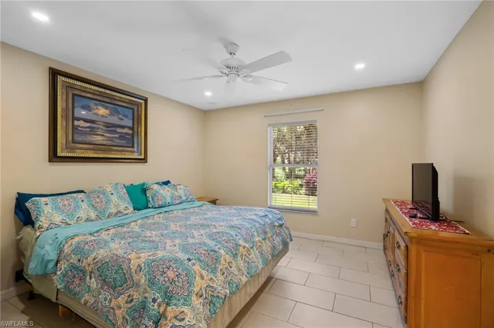 Bedroom featuring recessed lighting, light tile patterned flooring, and ceiling fan
