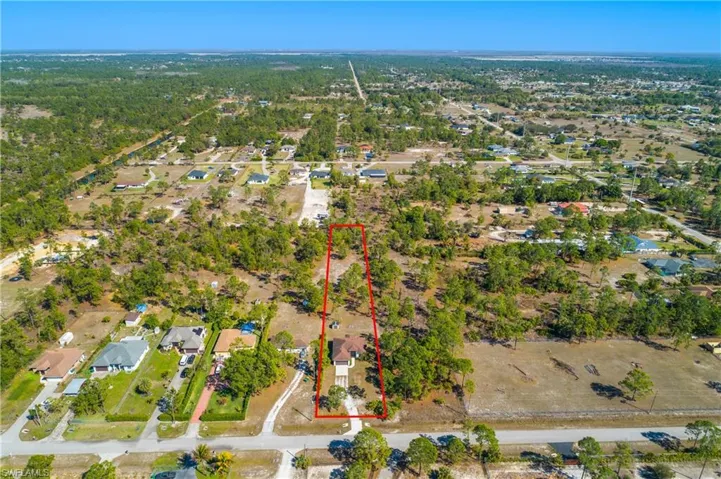 Aerial perspective of suburban area featuring property boundaries highlighted