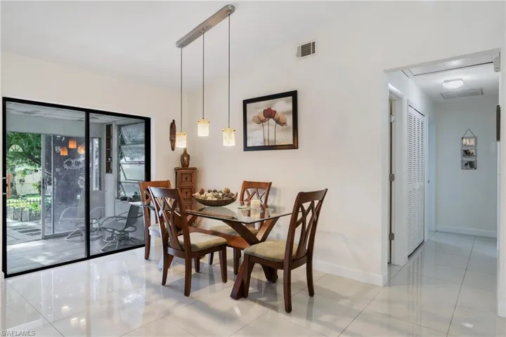 Dining area with light tile patterned flooring