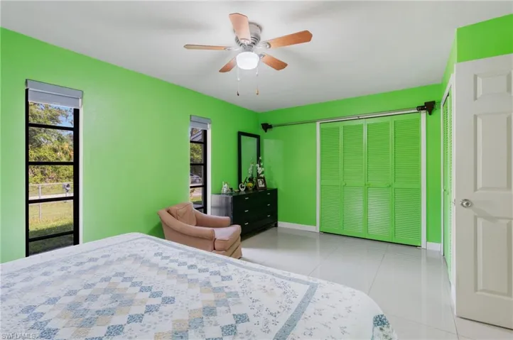 Tiled bedroom featuring a closet and ceiling fan